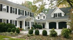 a large white house with black shutters