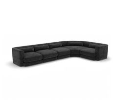 a large black sectional couch sitting on top of a white floor