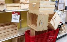 a red shopping cart in a store filled with wooden crates