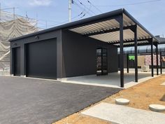 an empty parking lot next to a building with a closed door on one side and two doors on the other