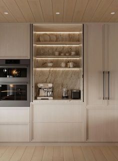 a kitchen with an oven, microwave and coffee maker on the counter in front of it