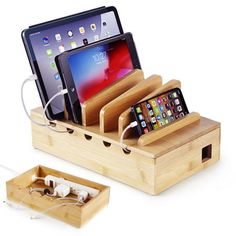 two cell phones and an ipad in a wooden charging station