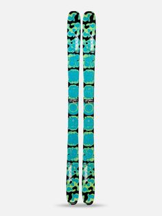 the back side of a pair of skis with blue and green designs on them