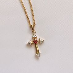 Very Pretty Cross Necklace All Done In Gold Plated Metal. In The Center Is A Rhodolite Garnet, These Are Slightly Pink In Color. And At The Top Of The Cross Is A Little Sparkling Cz. The Cross Measures Just Under 1 Inch Long, And Just Over 1/2” Wide. The Necklace Measures 18 Inches Long With A Lobster Claw Clasp. Plus It Has A 3 Inch Extension, So You Can Wear This As Long Is 21 Inches. It Is Brand New, Unworn. I Will Include A Gift Box For You. Ruby Cross Necklace, Red Cross Necklace, Fem Style, Pretty Cross, Nose Piercing Ring, Cross Necklace Gold, Easter Color, Emerald Green Necklace, Earthy Jewelry