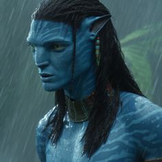 a man with long hair and blue makeup in the avatar movie avatar, standing in the rain