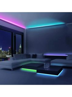 a living room filled with lots of furniture next to a large window and a view of the city at night