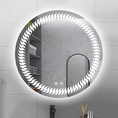 a bathroom mirror that has a circular light on the wall above it and a sink in front of it