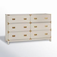 a white dresser with gold handles and drawers