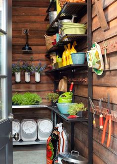 an outdoor kitchen with shelves full of food and utensils