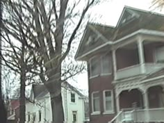 a blurry image of houses and trees on a street