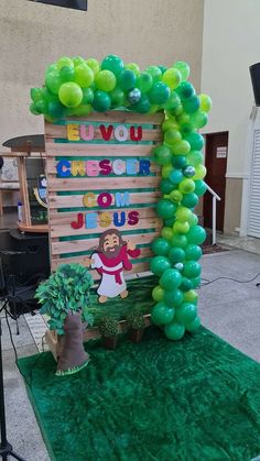 an arch made out of wooden pallets with balloons attached to it and a sign that says, i love you creator jesus