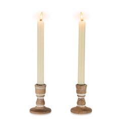 two white candles sitting next to each other