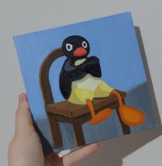 a painting of a penguin sitting on a chair with an orange spoon in it's hand