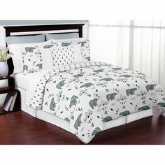 a bed with white sheets and blue bears on it