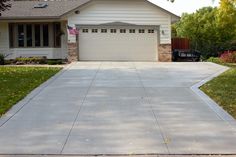 a driveway in front of a house with an american flag on it