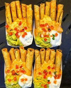 four plates filled with tacos and burritos on top of a grilling pan