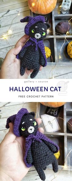 a hand holding a crocheted halloween cat in front of a box with pumpkins