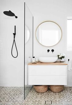 a bathroom with a sink, mirror and shower head in the middle of the room