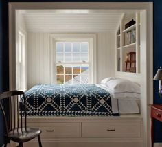 a bedroom with blue walls and white furniture