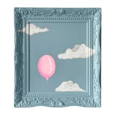 a pink balloon floating in the sky on a blue frame with white clouds and gray background