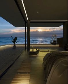 a bedroom with an ocean view at night