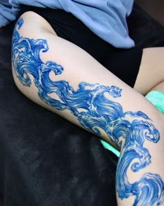 a person with blue tattoos on their legs