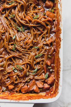 a casserole dish filled with noodles and meat