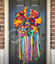 a colorful wreath on the front door of a house