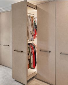 an open closet with clothes on hangers