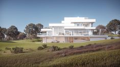 a large white house sitting on top of a lush green hillside