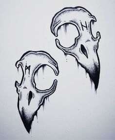 two black and white drawings of skulls with horns