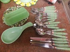 there are many green utensils on the counter