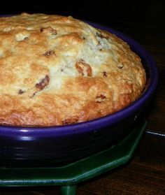 a blue bowl filled with food on top of a wooden table