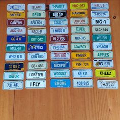 many different license plates on a wooden table