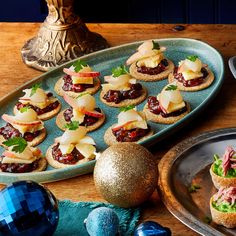 small appetizers are arranged on a platter next to an ornament