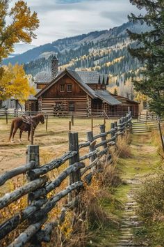 a horse is standing in front of a log cabin with mountains in the back ground