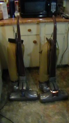 two vacuums that are sitting on the floor