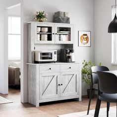 a kitchen with a microwave, cabinets and table in it's centerpieces