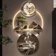 two clocks are on the wall with mountains and trees in front of them, one is lit up