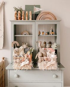 a cabinet with some stuffed animals in it