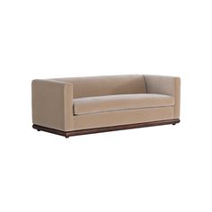 a beige couch sitting on top of a wooden frame