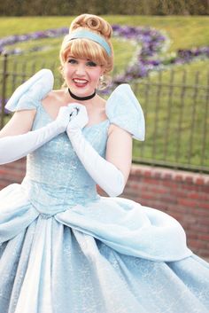 a woman in a blue dress and white gloves