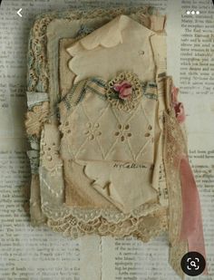 an old book with lace and fabric on it