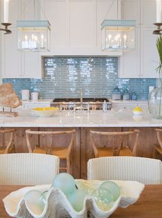 a kitchen filled with lots of counter top space next to a dining room table and chairs