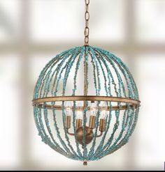 a chandelier with beads hanging from it's sides and two lights in the middle