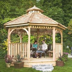 two people sitting in a wooden gazebo