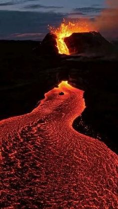 the lava is glowing red and orange as it moves through the air with water running down it