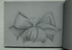 a pencil drawing of a bow on top of a book