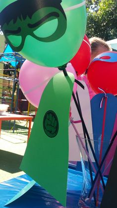 balloons with masks on them are in a vase