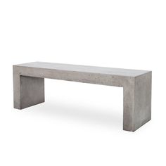 a concrete bench sitting on top of a white floor